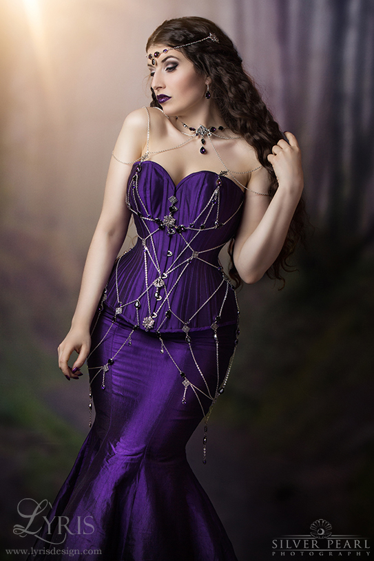 La Esmeralda purple silk corset and fishtail skirt with silver chain and crystal web